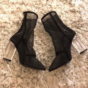 Mesh black ankle boots with a clear heel.